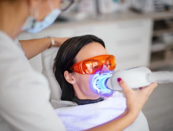 Dentist Whitening Teeth of a patient