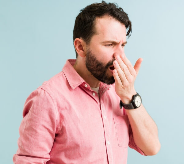 Man Facing Bad Breath - Get Treated at S&C Dental Beverly Hills