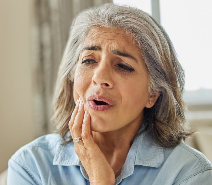 older woman facing teeth pain due to decay – Rotten teeth treatment in CA