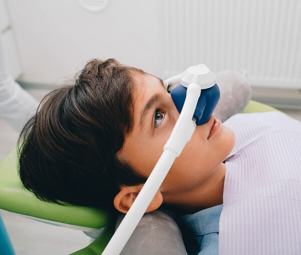 A doctor is providing sedation dentistry treatment to a patient in Beverly Hills, CA.