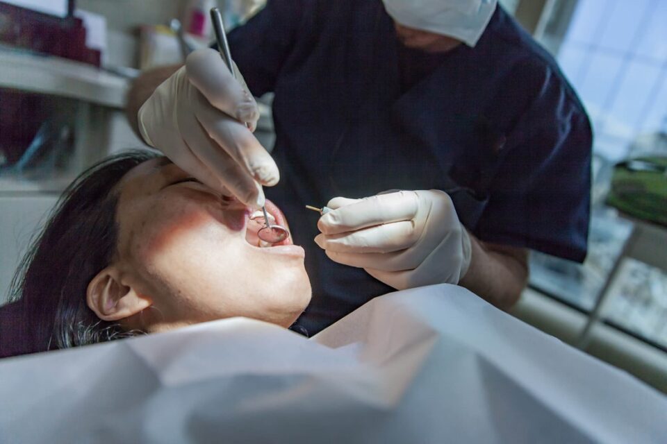 A dentist working on a patient's teeth