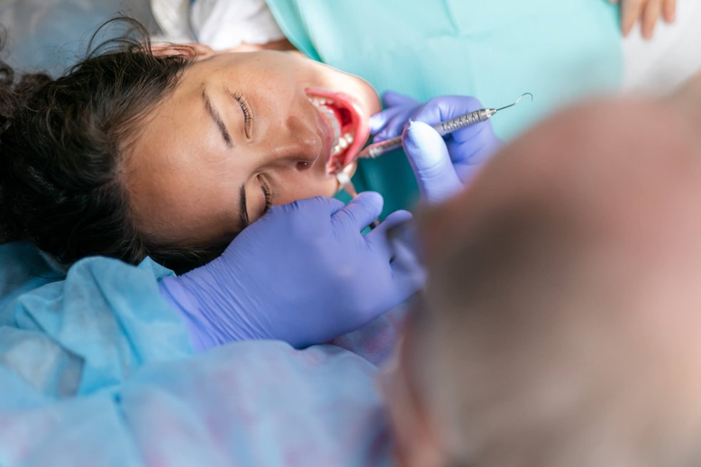A dentist examining a person's teeth
