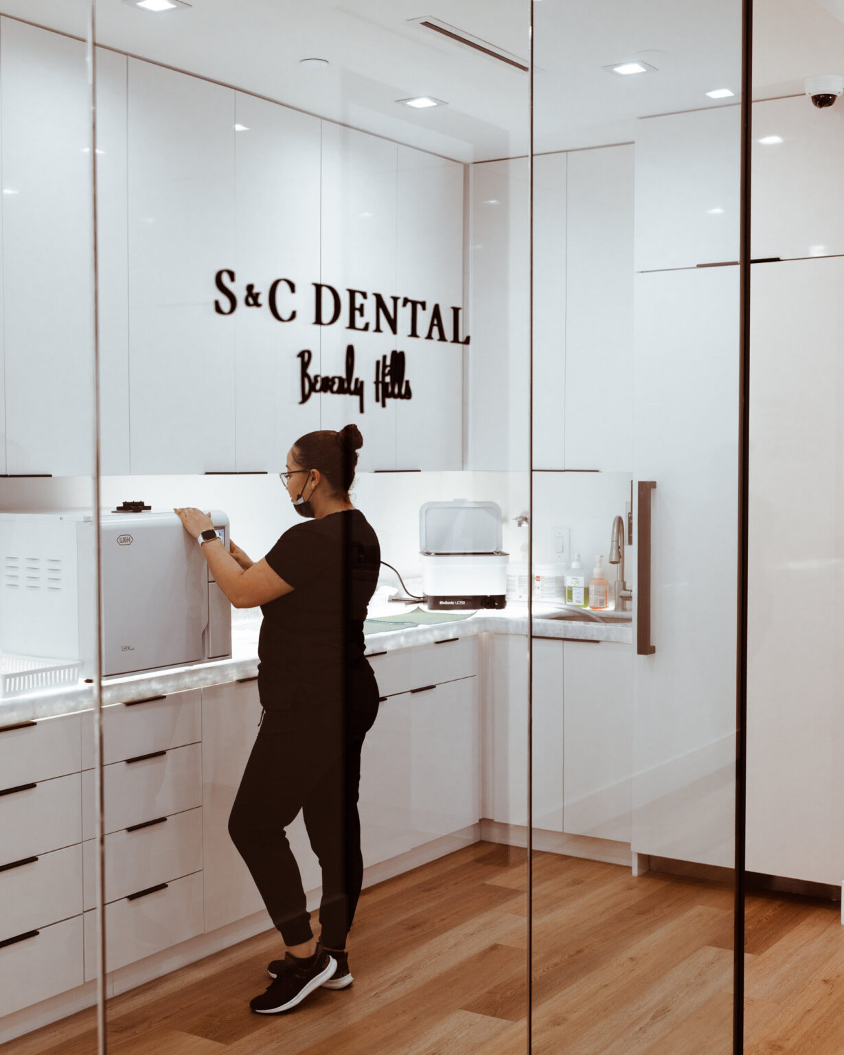 A team member preparing instruments in the sterilization room at S&C Dental Beverly Hills