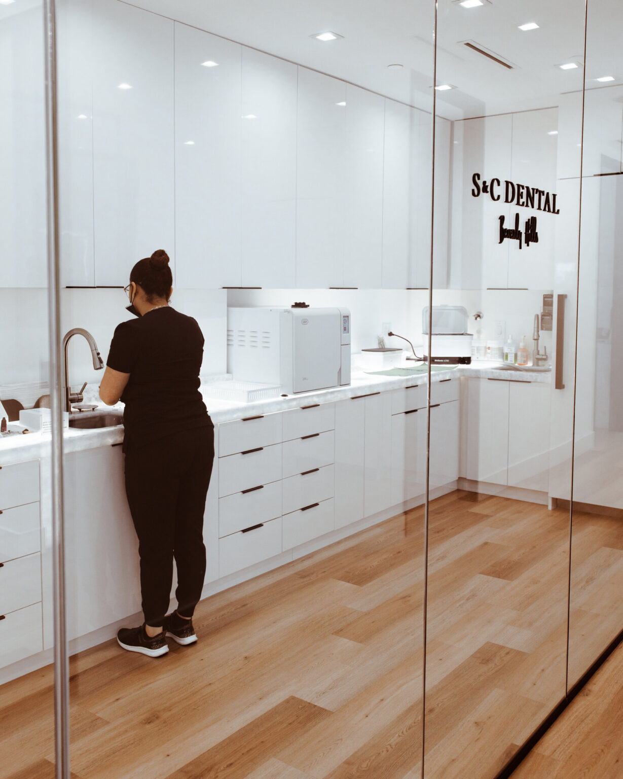 A team member at the instrument preparation counter at S&C Dental Beverly Hills