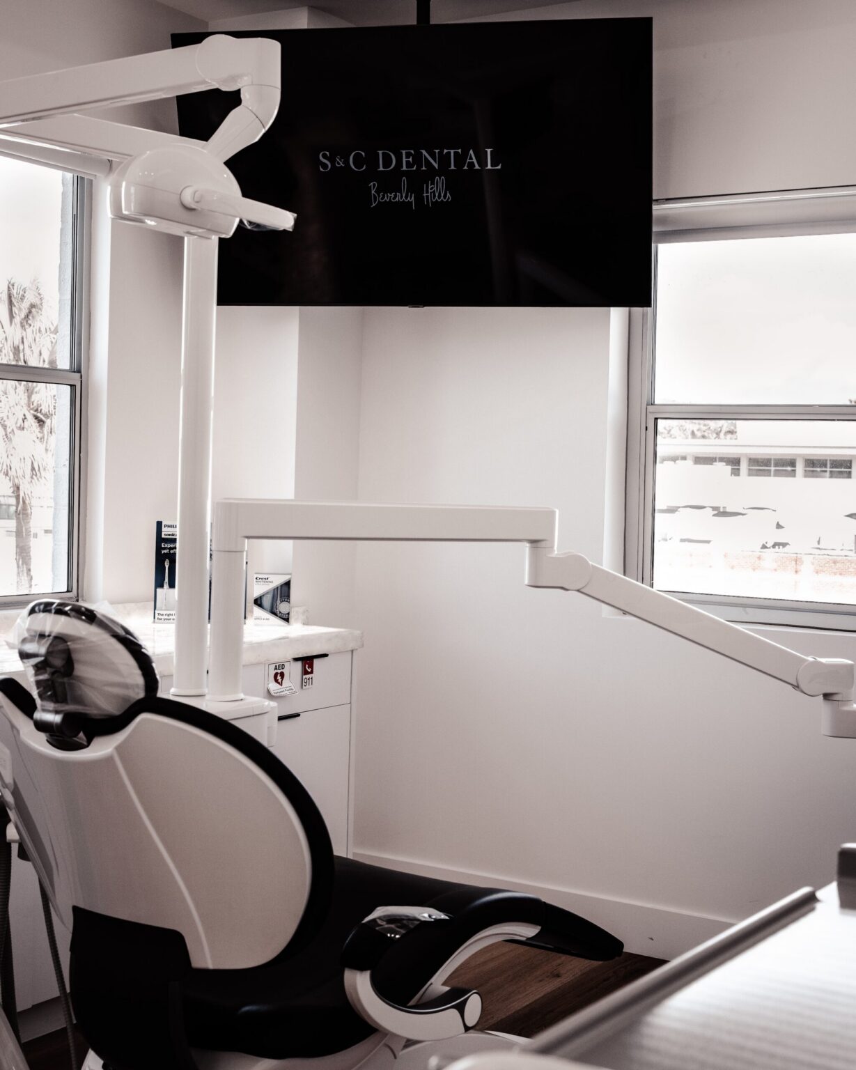 A treatment room and overhead monitor at S&C Dental Beverly Hills