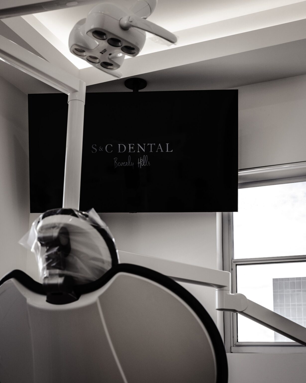 An overhead patient screen in a treatment room at S&C Dental Beverly Hills