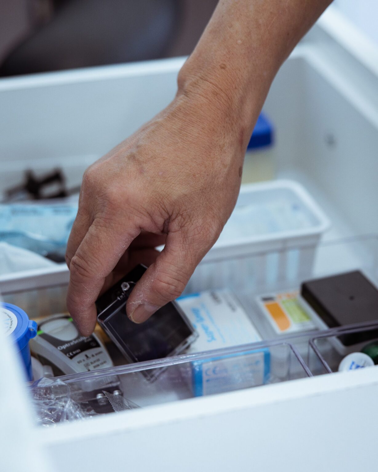 A clinician selecting an instrument from a prepared tray