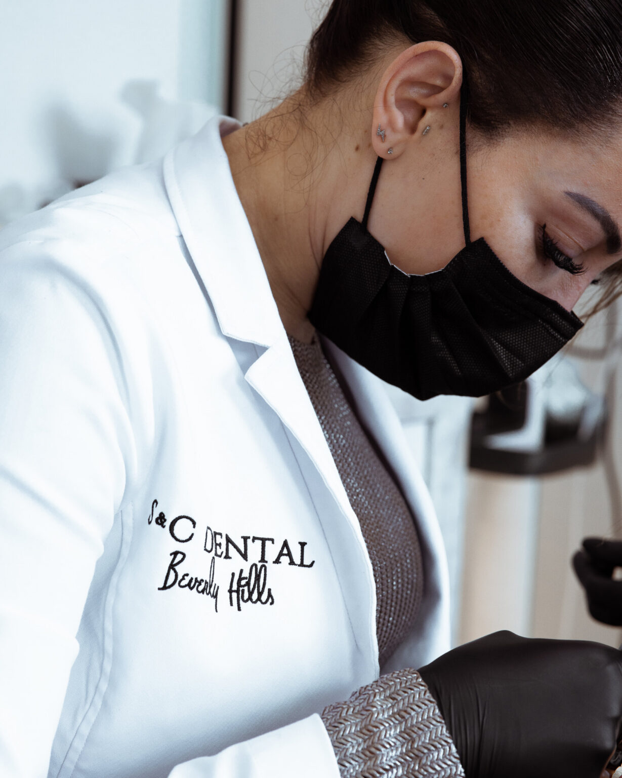 A clinician in an S&C Dental Beverly Hills embroidered coat
